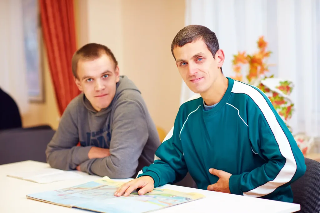 Special needs people at a desk.